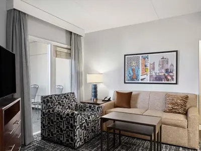 a living room with a couch and a chair at Homewood Suites Columbus - Airport in Columbus