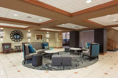 a lobby with couches and chairs and tables at Homewood Suites Columbus - Airport in Columbus