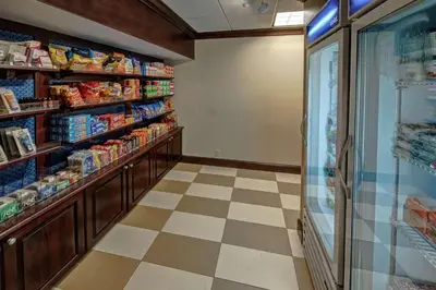 a grocery store aisle with shelves of food at Hampton Inn Cambridge in Cambridge