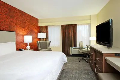 a hotel room with a bed and a flat screen tv at Hampton Inn & Suites Columbus-Downtown, Ohio in Columbus