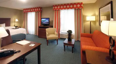 a hotel room with a bed and a couch at Hampton Inn & Suites Columbus Polaris in Columbus
