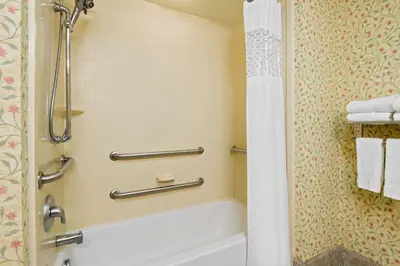a bathroom with a tub and a shower with towels at Hampton Inn & Suites Columbus Polaris in Columbus