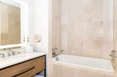 a bathroom with a white tub and a sink and a bath tub at Hilton Columbus/Polaris in Columbus
