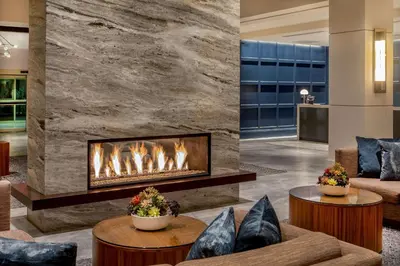 a fireplace in the lobby of a hotel at Hilton Columbus/Polaris in Columbus