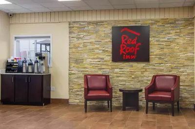 a waiting room with two chairs and a red roof tavern sign at Red Roof Inn Perrysburg in Perrysburg