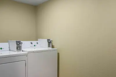 a laundry room with a washer and dryer at Red Roof Inn Perrysburg in Perrysburg