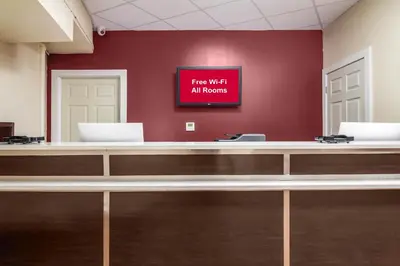 a waiting room with a sign that reads fire wait all fronts at Red Roof Inn Perrysburg in Perrysburg
