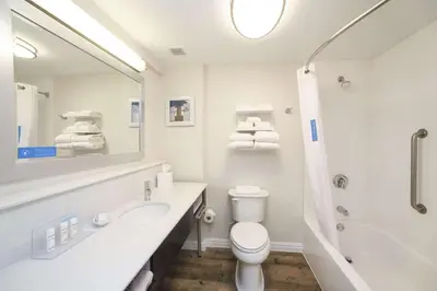 a white bathroom with a sink and a toilet at Hampton Inn Cincinnati Eastgate in Eastgate