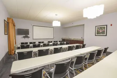 an empty lecture room with a long table and chairs at Hampton Inn Cincinnati Eastgate in Eastgate