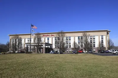 a large building with an american flag in front of it at Hampton Inn Cincinnati Eastgate in Eastgate