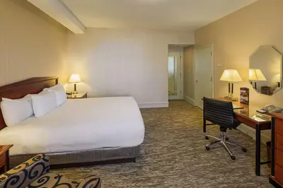 a hotel room with a bed and a desk at Hilton Cincinnati Netherland Plaza in Cincinnati