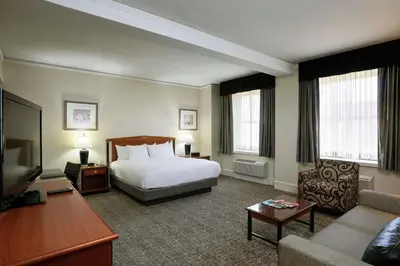 a hotel room with a bed and a couch at Hilton Cincinnati Netherland Plaza in Cincinnati