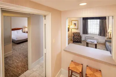 a hotel room with a bed and a living room at Hilton Cincinnati Netherland Plaza in Cincinnati