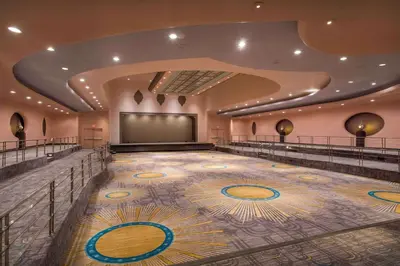 a large room with a stage and a screen at Hilton Cincinnati Netherland Plaza in Cincinnati