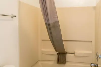 a shower curtain in a bathroom with a toilet at Motel 6 Florence, KY - Cincinnati Airport in Florence