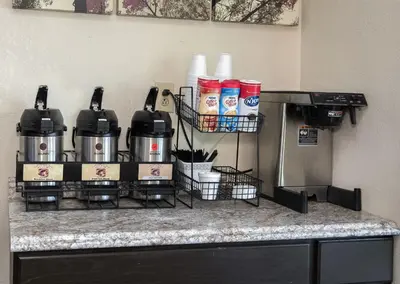 a counter with two coffee machines on a counter top at Red Roof Inn Cincinnati East - Beechmont in Cherry Grove