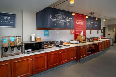 a kitchen with a counter with a microwave and a counter sidx sidx at Hampton Inn Charleston Downtown in Charleston