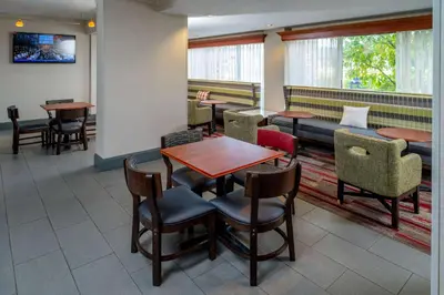 a restaurant with tables and chairs and a couch at Hampton Inn Charleston Downtown in Charleston