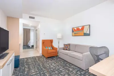 a living room with a couch and a chair at Hilton Garden Inn Cincinnati/Sharonville in Sharonville