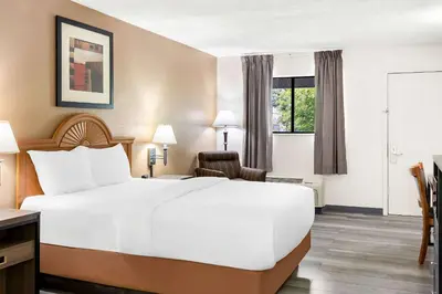 a hotel room with a large bed and a window at Quality Inn Middleburg Heights near Cleveland Airport in Middleburg Heights