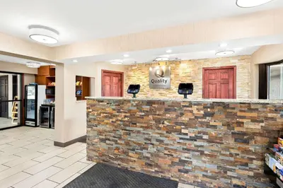a lobby of a hospital with a brick wall at Quality Inn Middleburg Heights near Cleveland Airport in Middleburg Heights