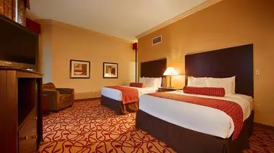 a hotel room with two beds and a flat screen tv at Best Western Park Hotel in Warren