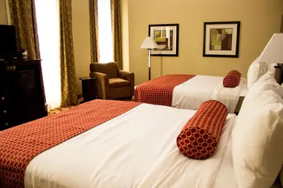 a hotel room with two beds and a chair at Best Western Park Hotel in Warren