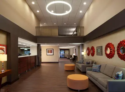 a lobby of a hospital with couches and tables at Hampton Inn Charleston-Southridge in Charleston