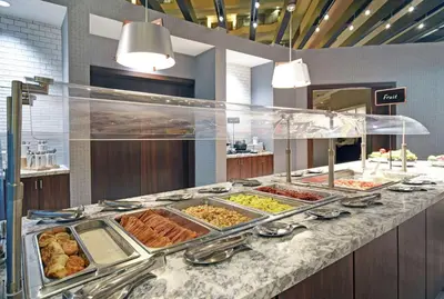 a buffet line with many different types of food at Embassy Suites Charleston in Charleston