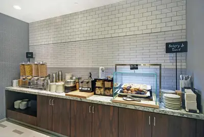 a kitchen with a counter with food on it at Embassy Suites Charleston in Charleston