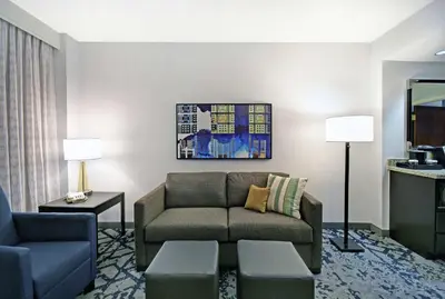 a living room with a couch and a chair at Embassy Suites Charleston in Charleston