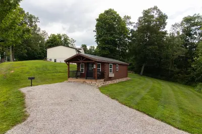 a small cabin in the middle of a field at The Cayo Cabin, Millersburg Ohio in Millersburg