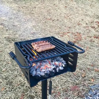 a grill with two hot dogs and vegetables on it at The Cayo Cabin, Millersburg Ohio in Millersburg