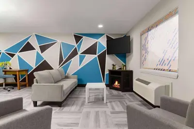 a living room with a couch and a fireplace at Days Inn by Wyndham Washington Court House in Washington Court House