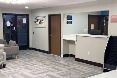 an office lobby with a reception desk and chairs at Days Inn by Wyndham Washington Court House in Washington Court House
