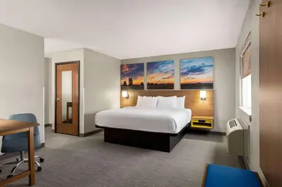 a hotel room with a bed and a desk at Days Inn by Wyndham Washington Court House in Washington Court House