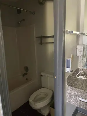 a bathroom with a toilet and a bath tub at Deerfield Inn in Xenia