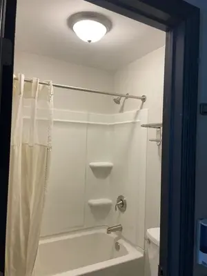 a bathroom with a shower and a toilet at Deerfield Inn in Xenia