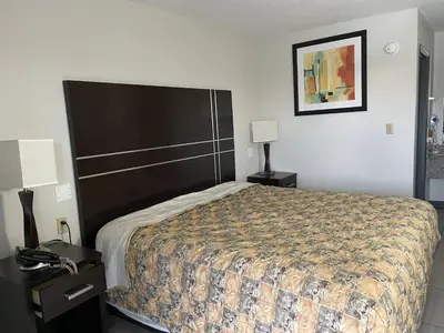 a bedroom with a large bed and two night stands at Deerfield Inn in Xenia