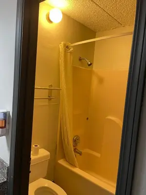 a bathroom with a shower and a toilet and a sink at Deerfield Inn in Xenia