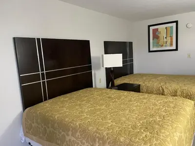 a hotel room with two beds and a lamp at Deerfield Inn in Xenia