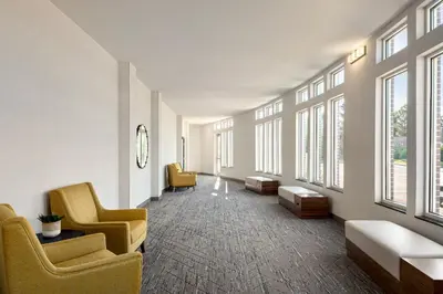 a hospital waiting room with yellow chairs and windows at Holiday Inn Express Richmond by IHG in Richmond