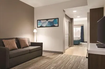 a living room with a couch and a television at Hilton Garden Inn Fort Wayne in Fort Wayne
