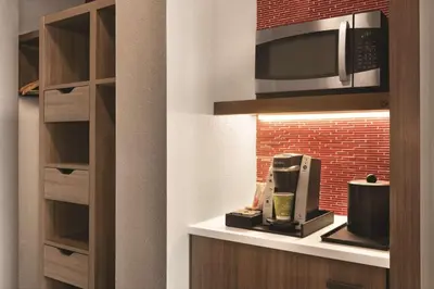 a kitchen with a microwave and a coffee maker at Hilton Garden Inn Fort Wayne in Fort Wayne