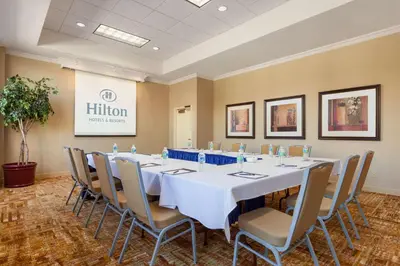 a conference room with a long table and chairs at Hilton Fort Wayne at the Grand Wayne Convention Center in Fort Wayne