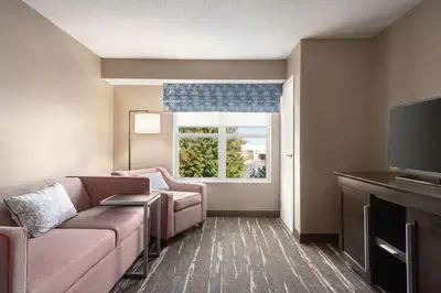 a living room with a couch and a window at Hampton Inn & Suites Fort Wayne-North in Fort Wayne