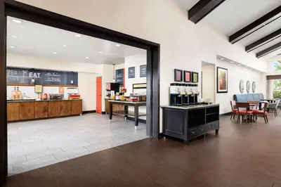 a large room with a store with a counter and chairs at Hampton Inn & Suites Fort Wayne-North in Fort Wayne