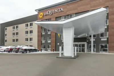 a building with awning in front of a parking lot at La Quinta by Wyndham Cleveland - Airport North in Cleveland