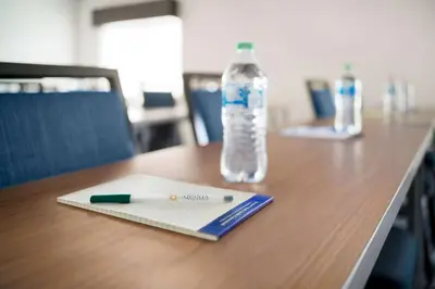 a pen and a bottle of water on a table at La Quinta Inn by Wyndham Columbus Dublin in Dublin