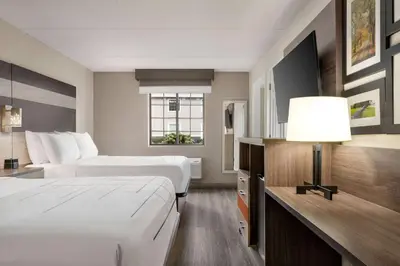 a hotel room with two beds and a lamp at La Quinta Inn Lexington-Horse Park in Lexington